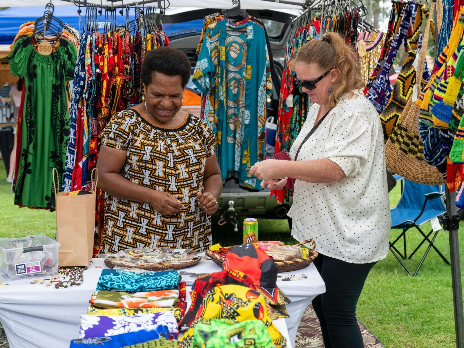 Vender selling a their stall.