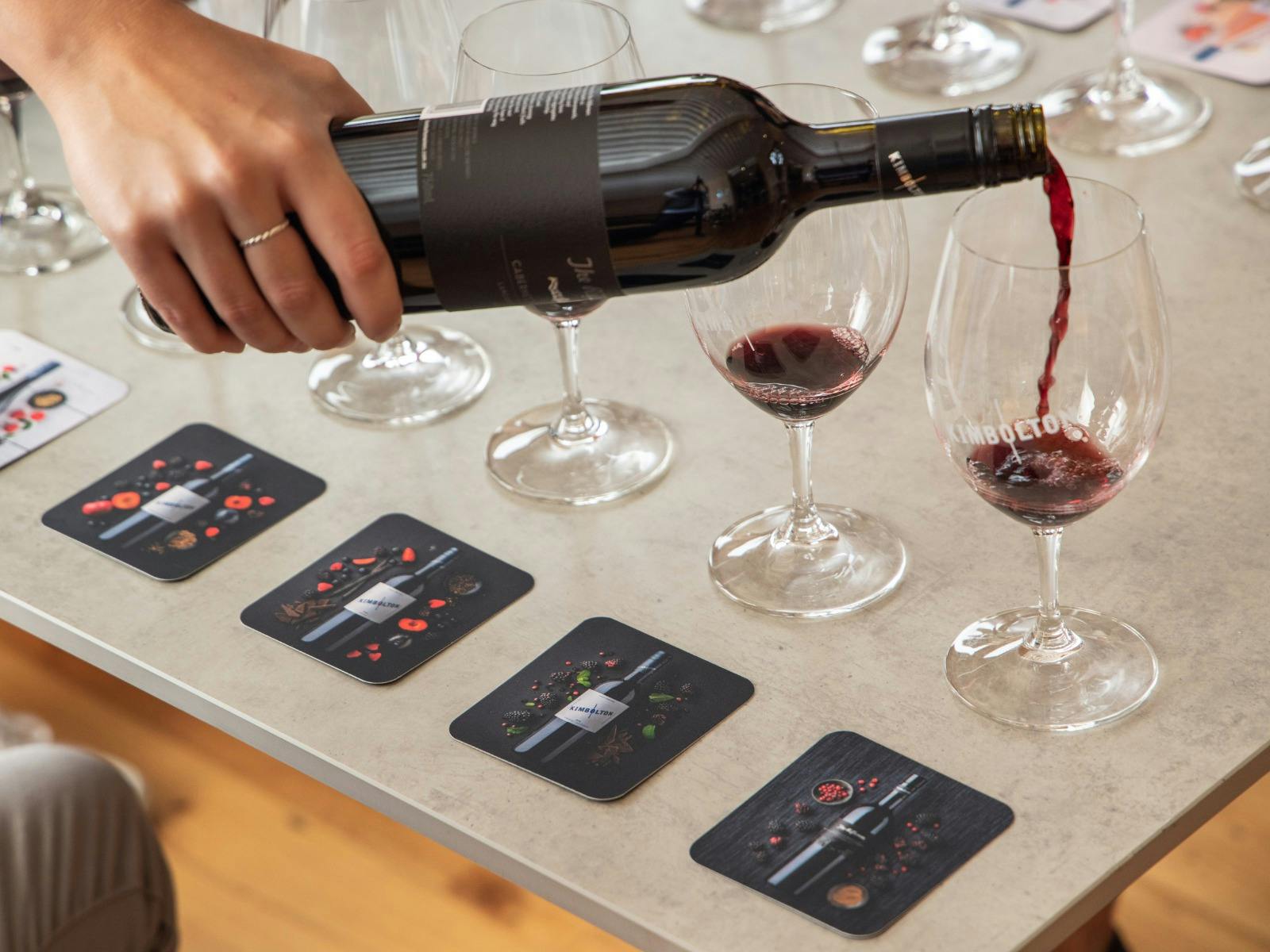 Image of a red wine tasting with a line up of glasses with red wine