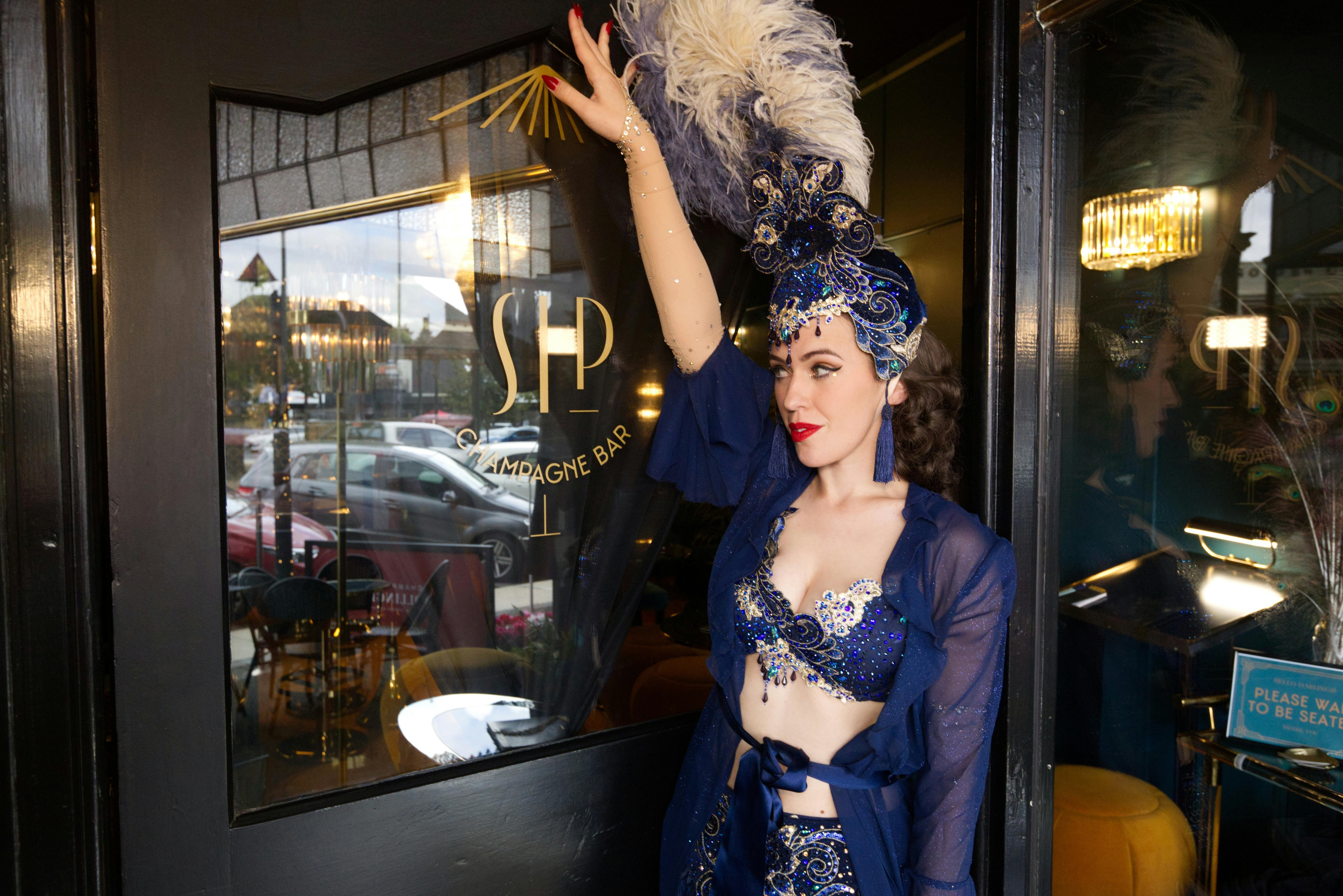 Burlesque dance standing at Sip Champagne Bar door