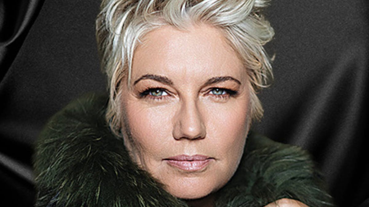 Melinda with short blonde hair swept up