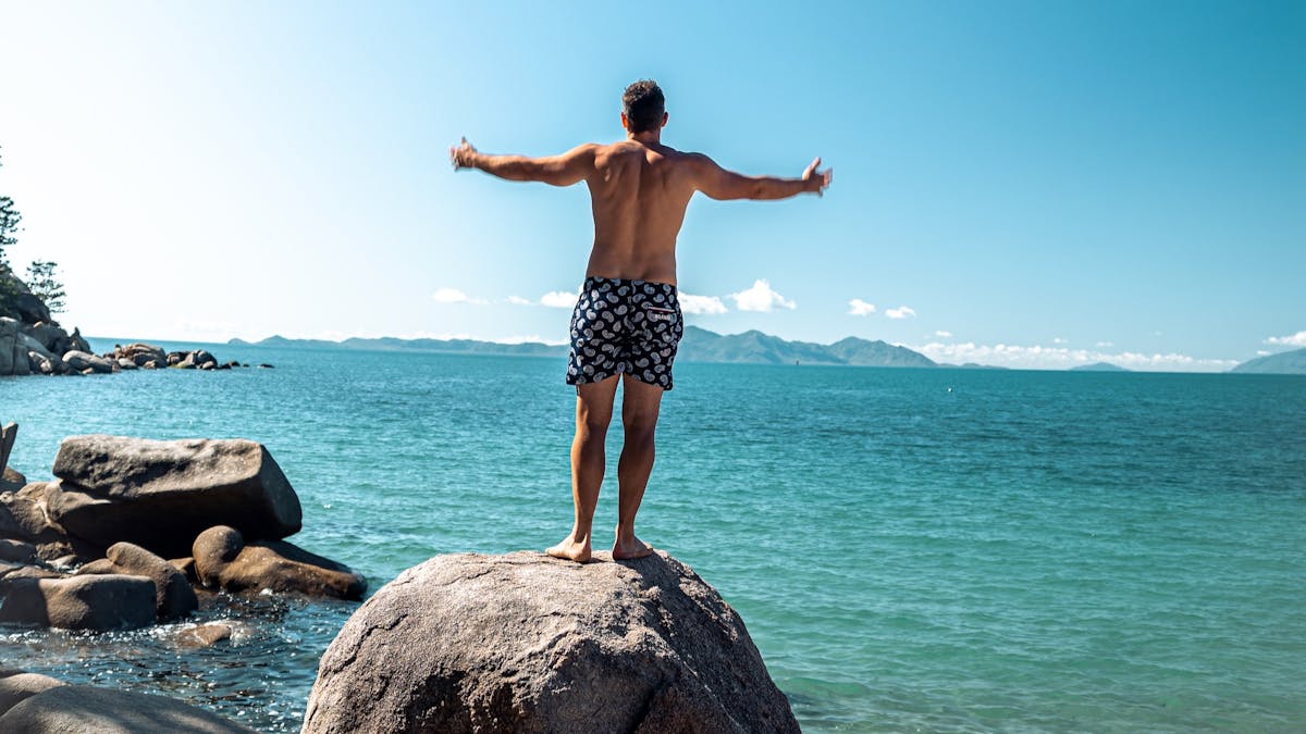 Man on a giant boulder