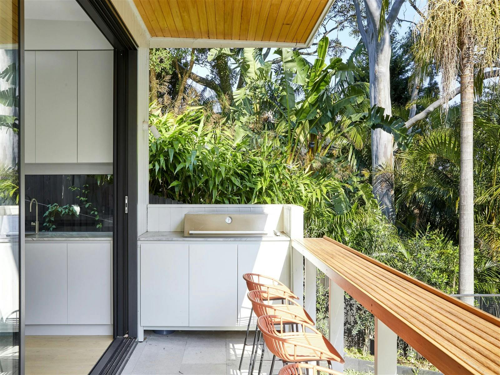 outdoor area complete with bar stools and many seating options