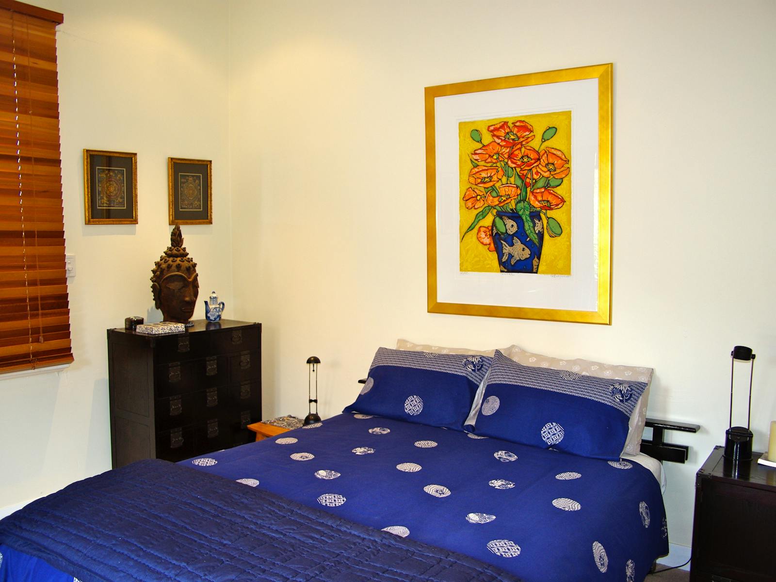 Queen size bedroom with original artwork and fine linen