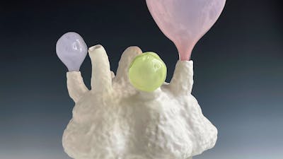 Lynda Draper artwork, made of glazed ceramic and studio blown glass, on grey background