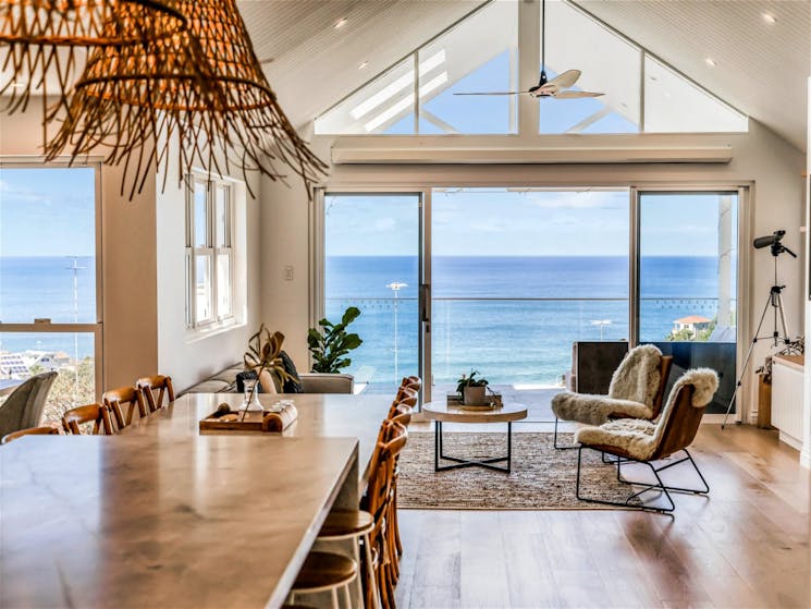 Open-plan dining that overflows through the living with stunning beach views