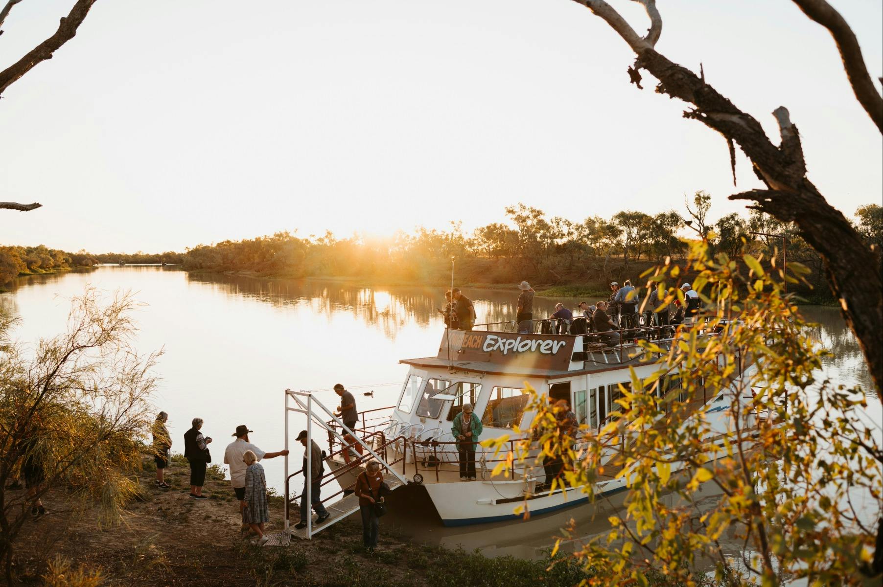 boat banked at shore with guests disembarking