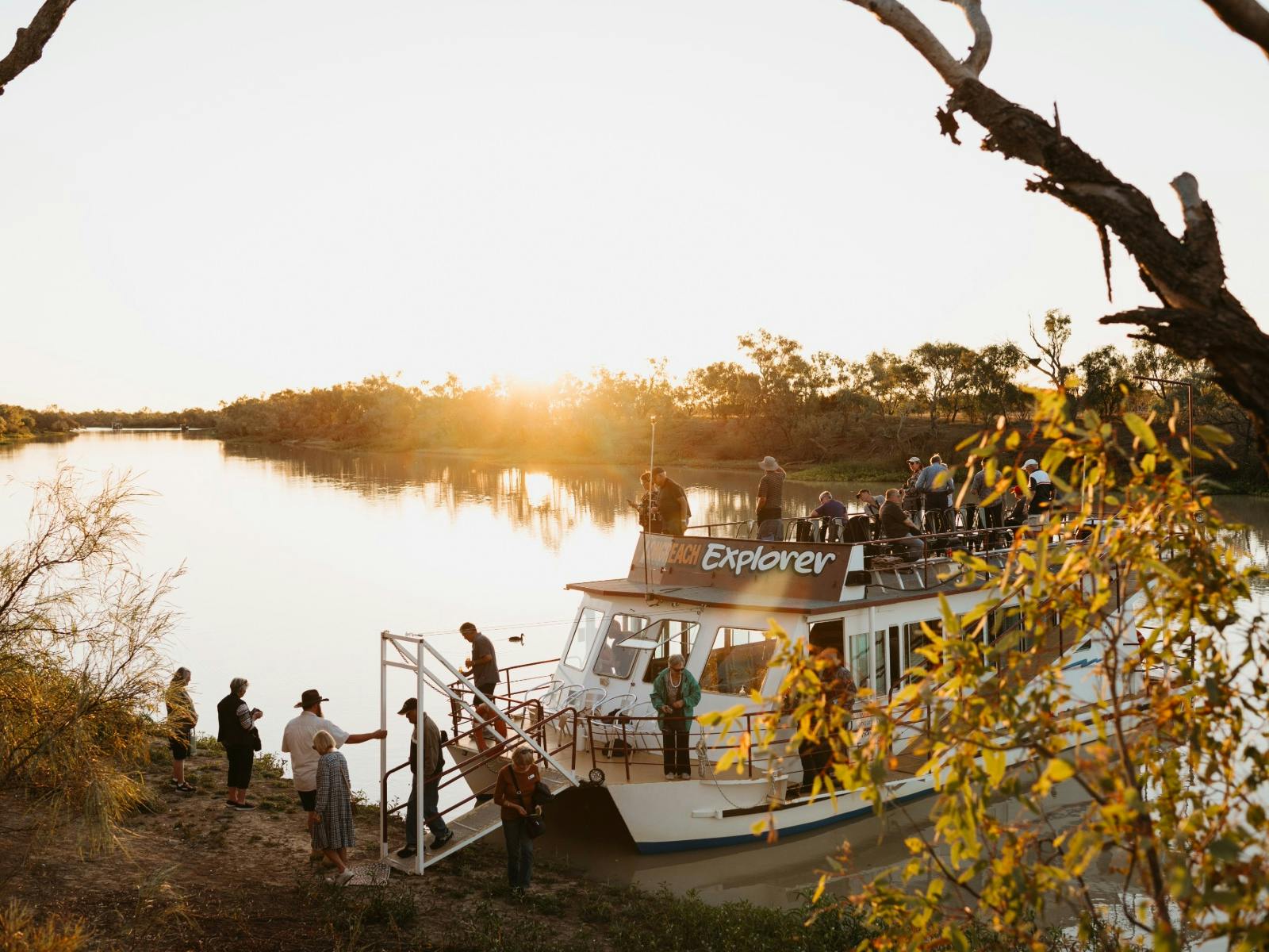 boat banked at shore with guests disembarking boat banked at shore with guests disembarking
