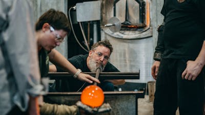 Artists glass blowing in the Hotshop