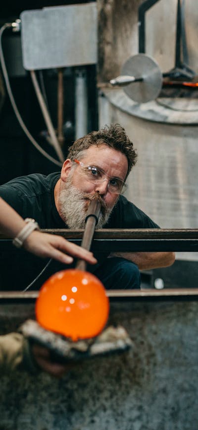 Artists glass blowing in the Hotshop