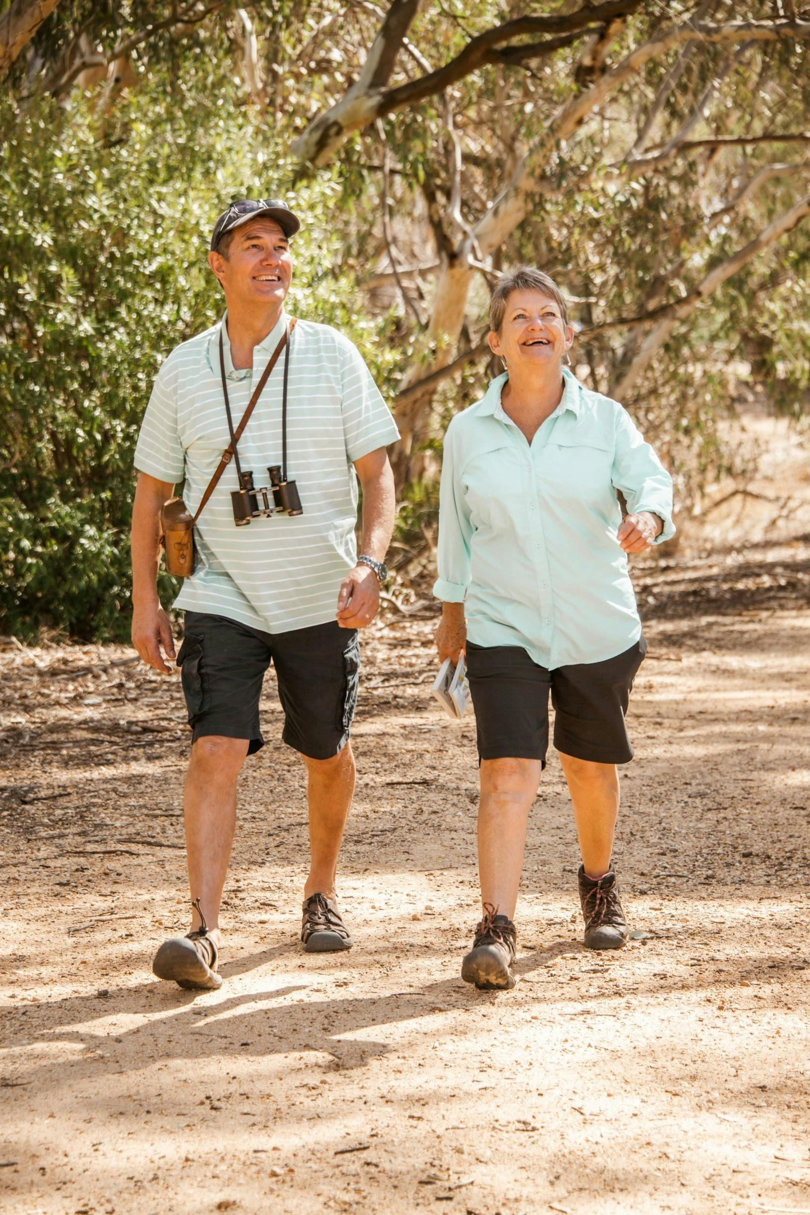 elderly couple walking along a sealed trail past the corowa wetlands