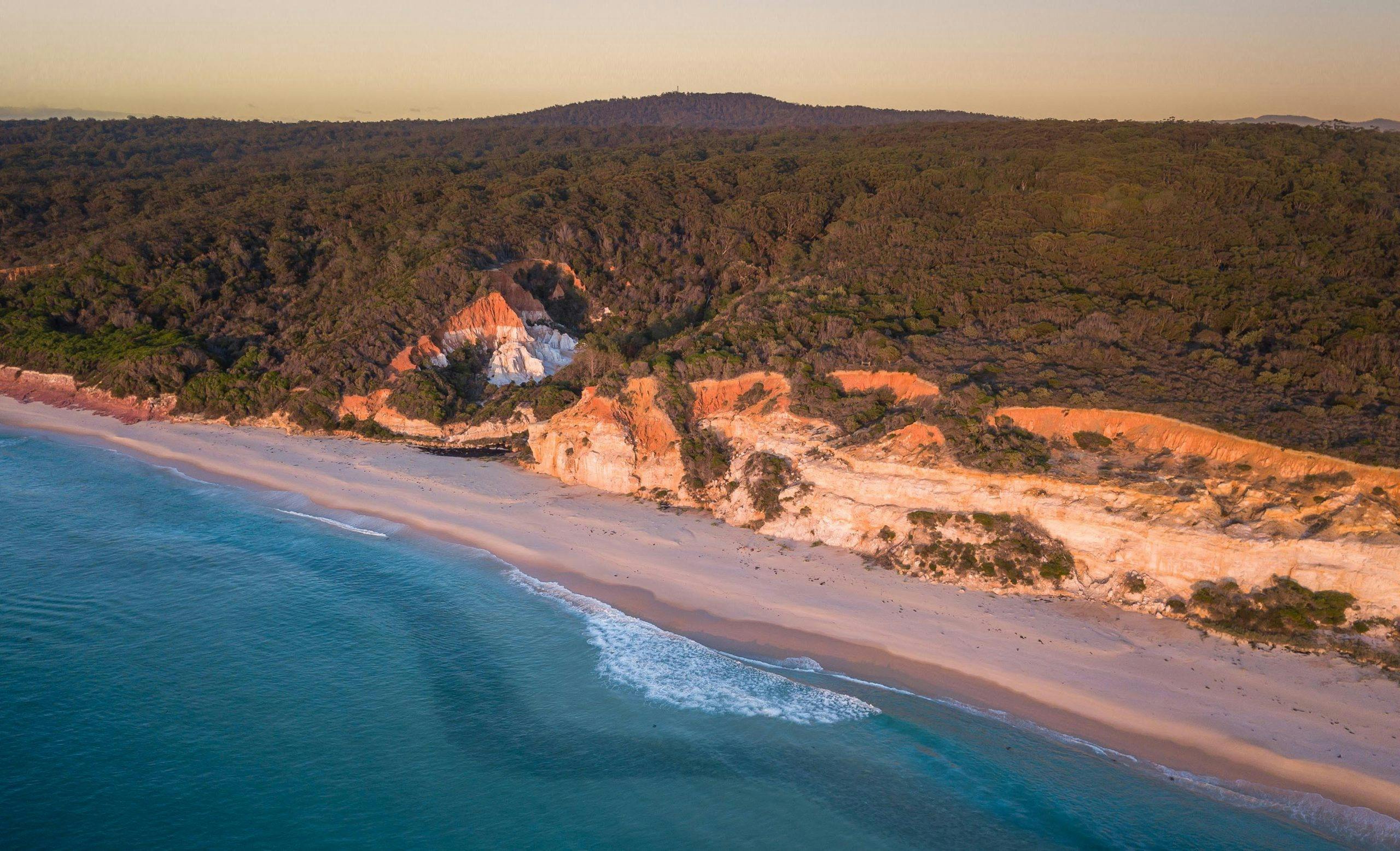 The vivid colours of the Pinnacles rock formation can be seen as an ariel shot including the beach