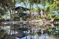 A wide shot of the Wetland Habitat landscape during the Stork Keeper Talk, with a group of visitors
