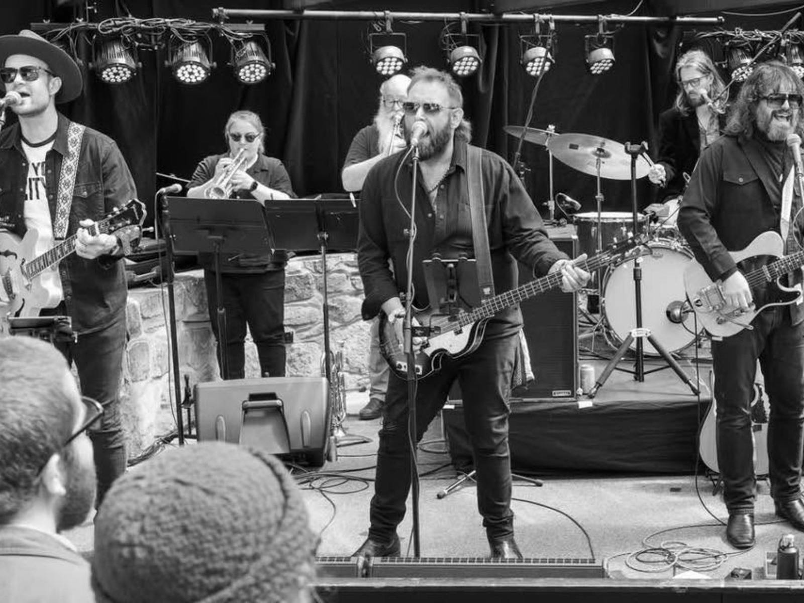 Black and white photo of The Beatles Show on stage featuring Tom Wolfe (centre)