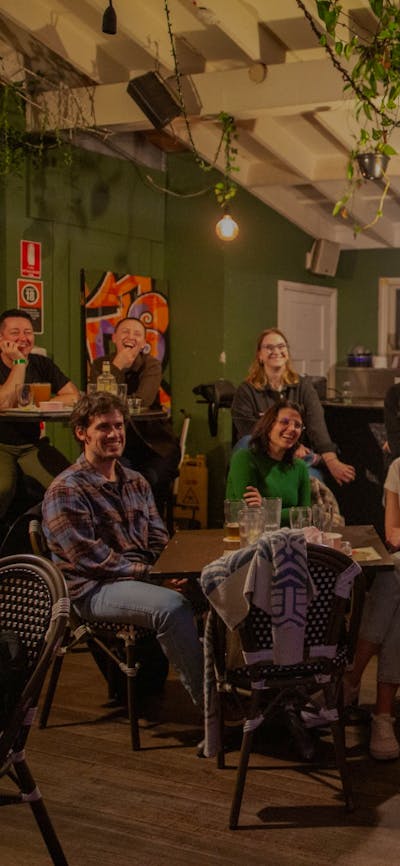 A speaker addressing a bar full of people