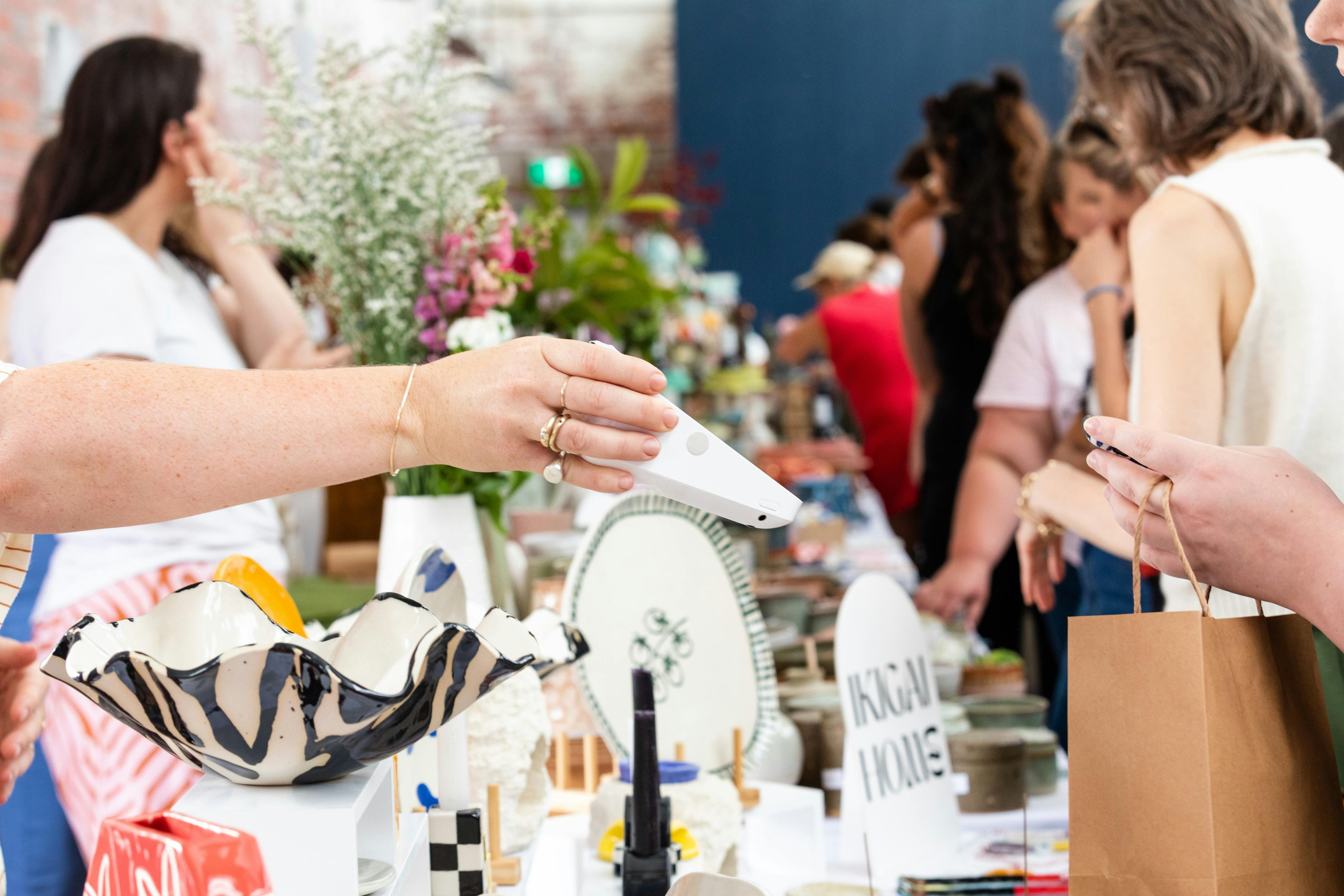 Crowds browsing handmade ceramics at the Geelong Ceramics Market inside Furphy Hall