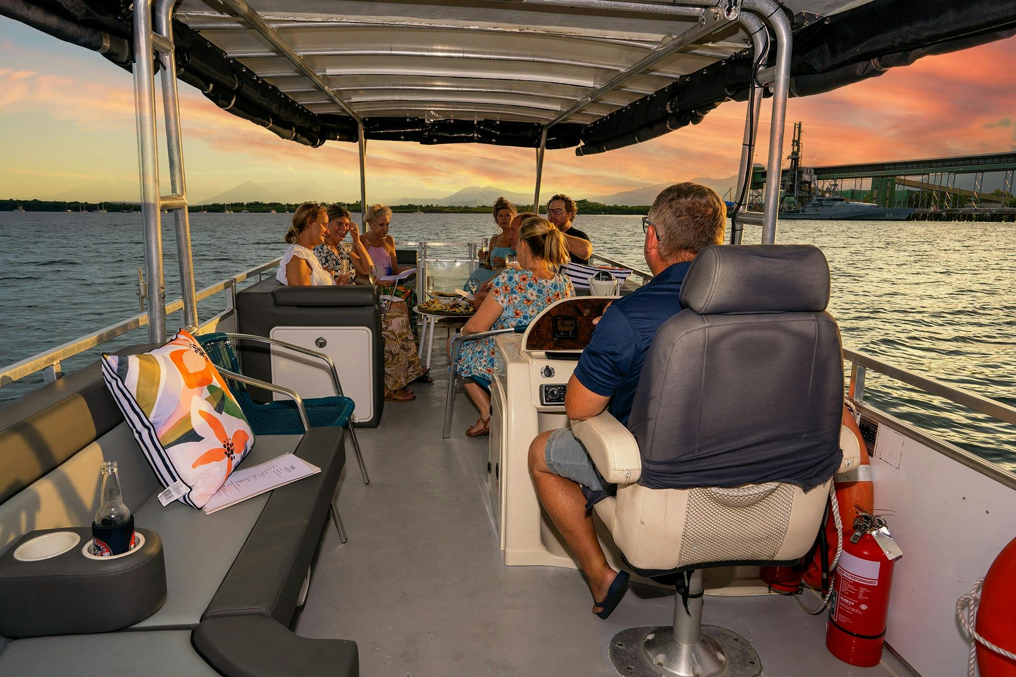 Wide angle of skipper and guests enjoying a stunning sunset on the Trinity Inlet near Cairns