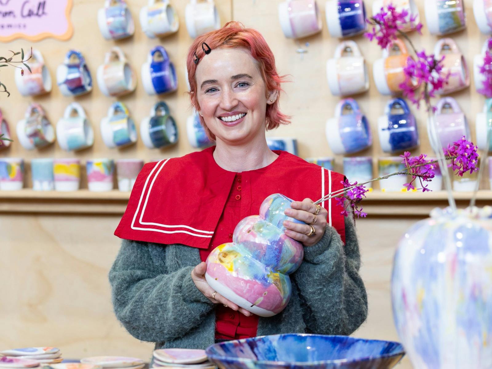 Rhiannon Gill Ceramics holding a colourful ceramic vase