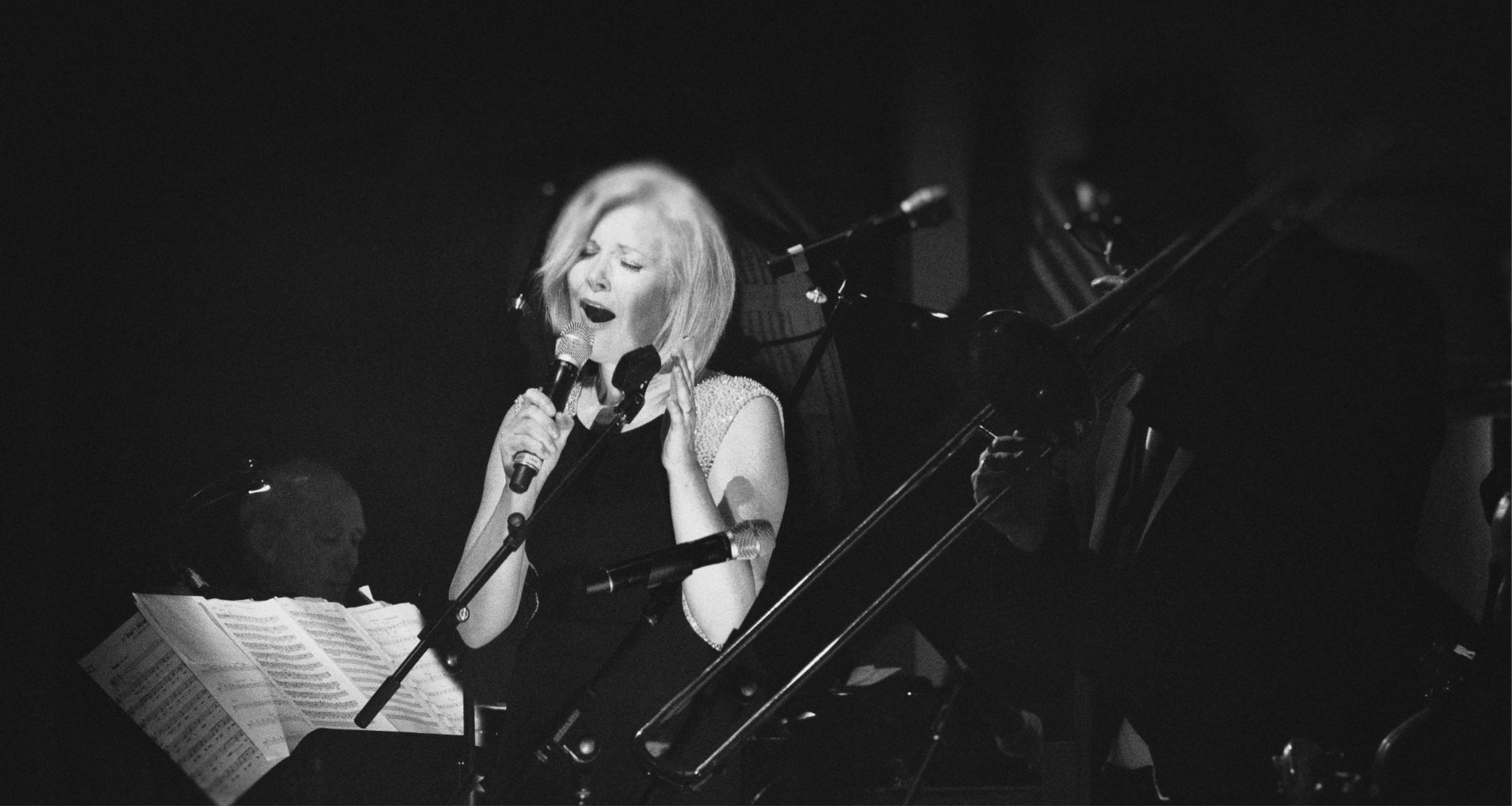 A black and white photo of Nicki Parrott performing
