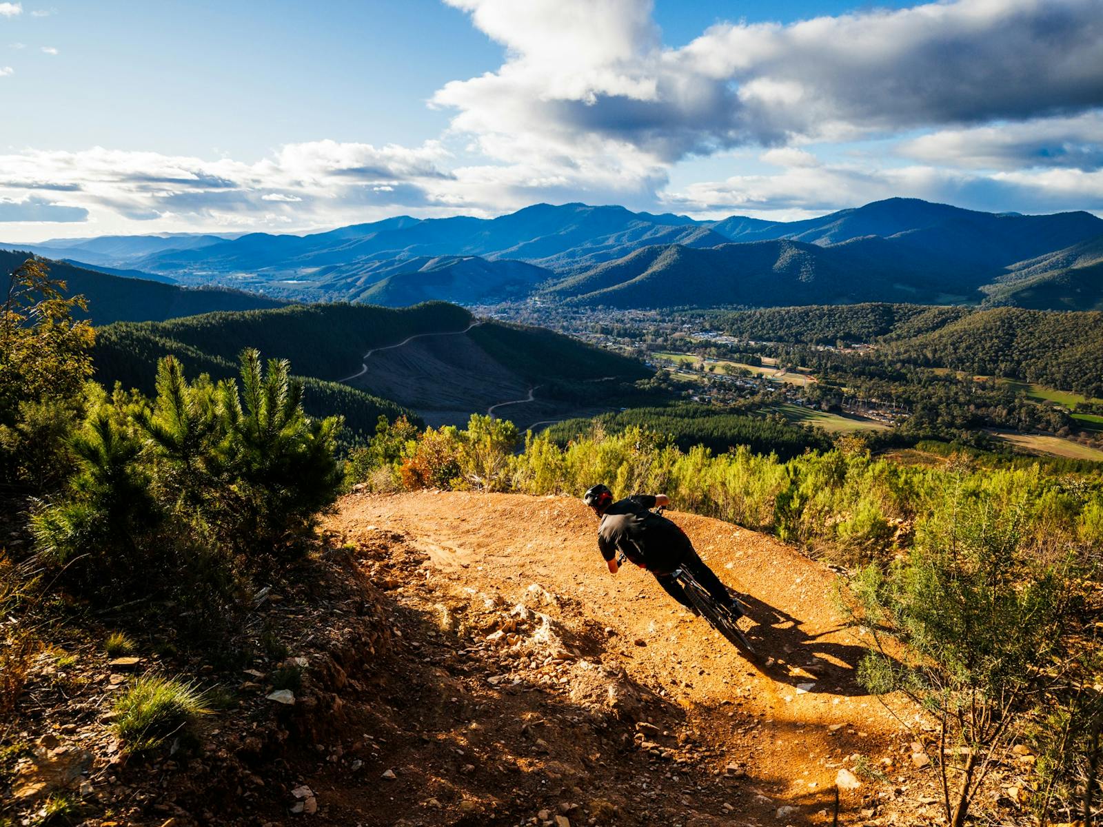 Riding at Mystic Bike Park with views of mountains