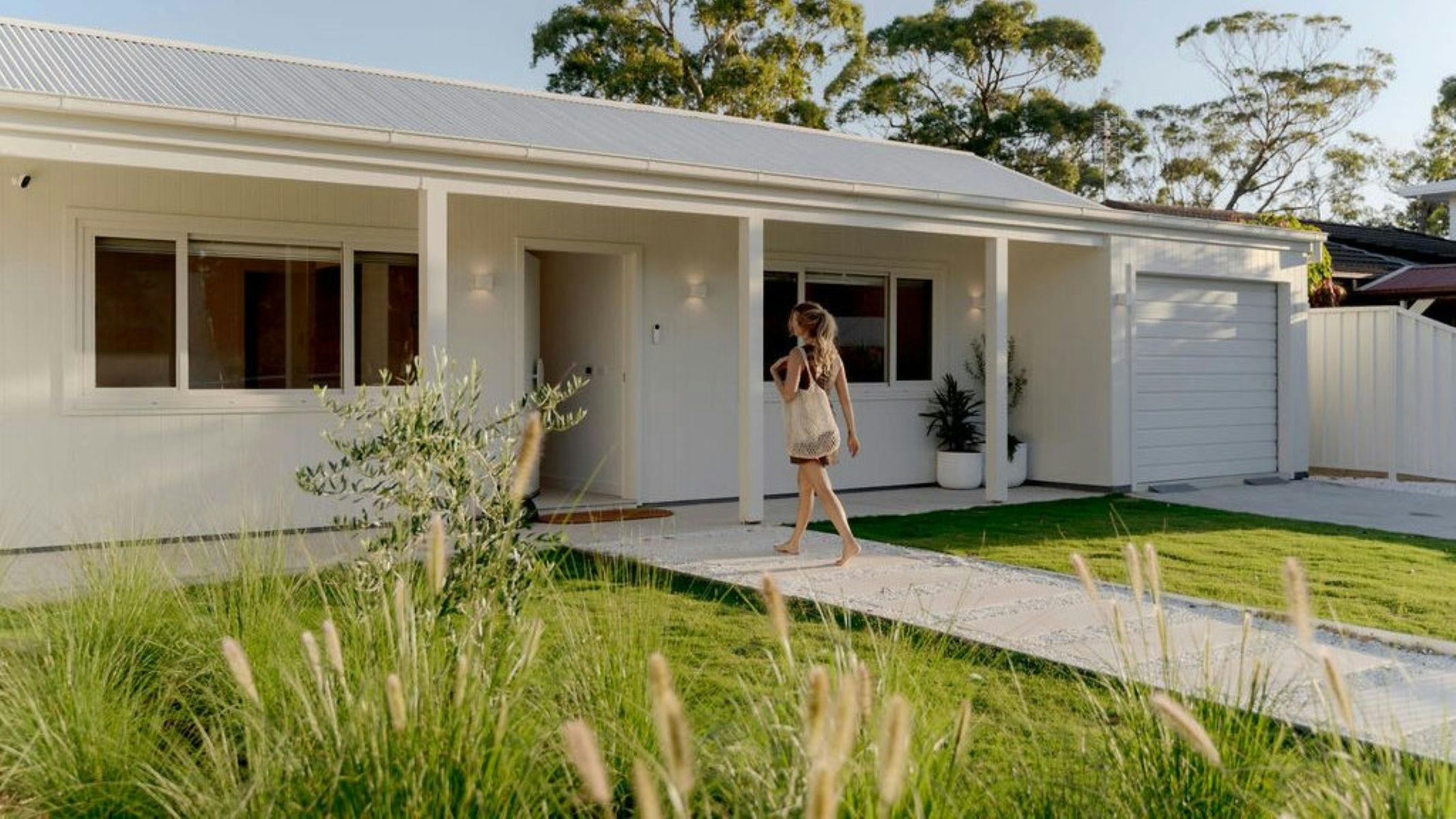 Image if front facade, guest is arriving and walking to the front door.