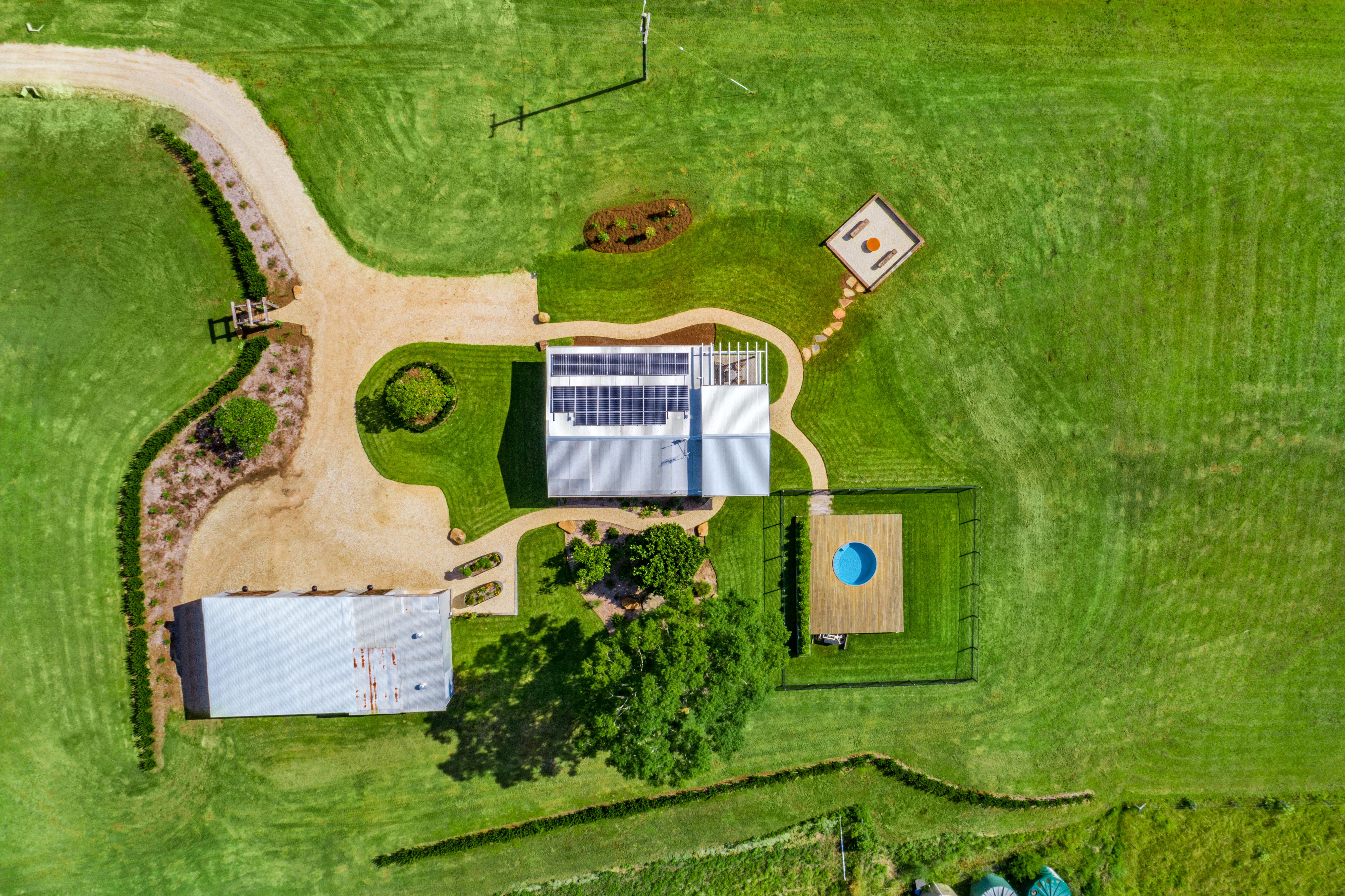 Aerial shot of Heartwood Farm Cottage, plunge pool, fire pit and shed