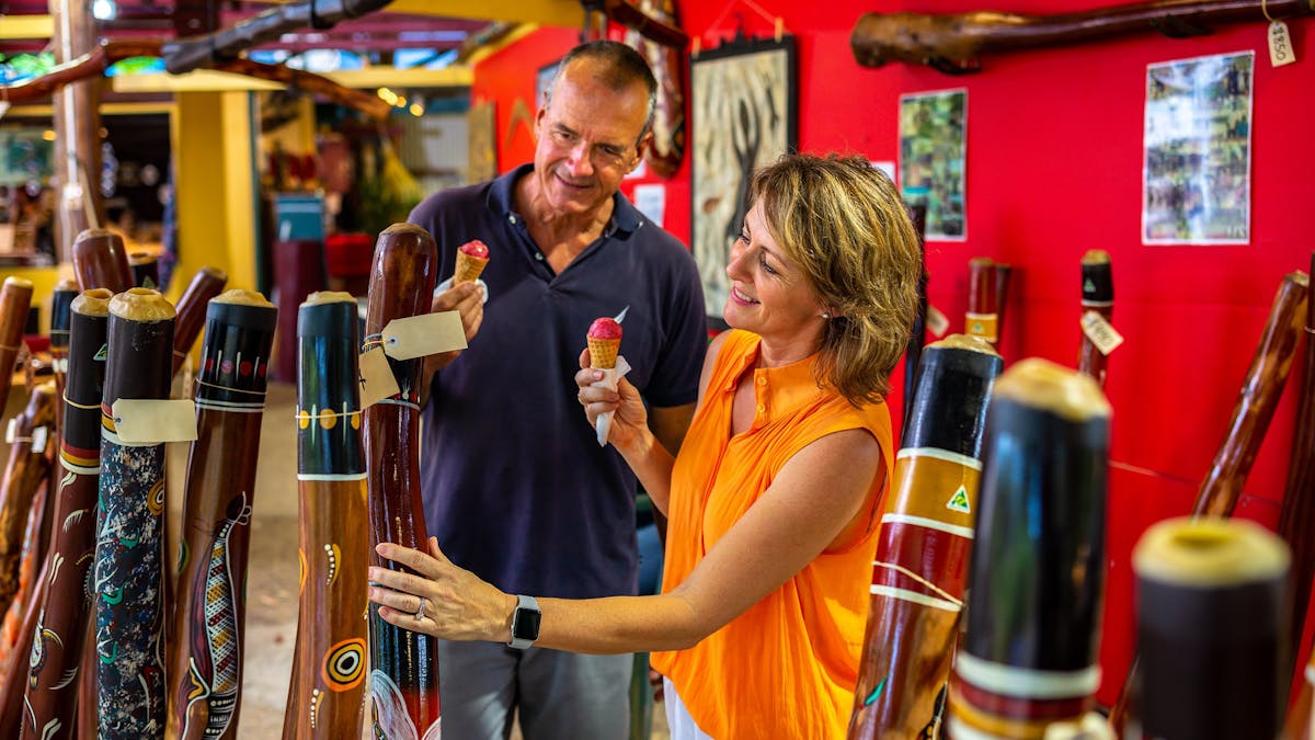Two people looking at market stalls in Kuranda