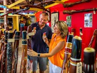 Two people looking at market stalls in Kuranda