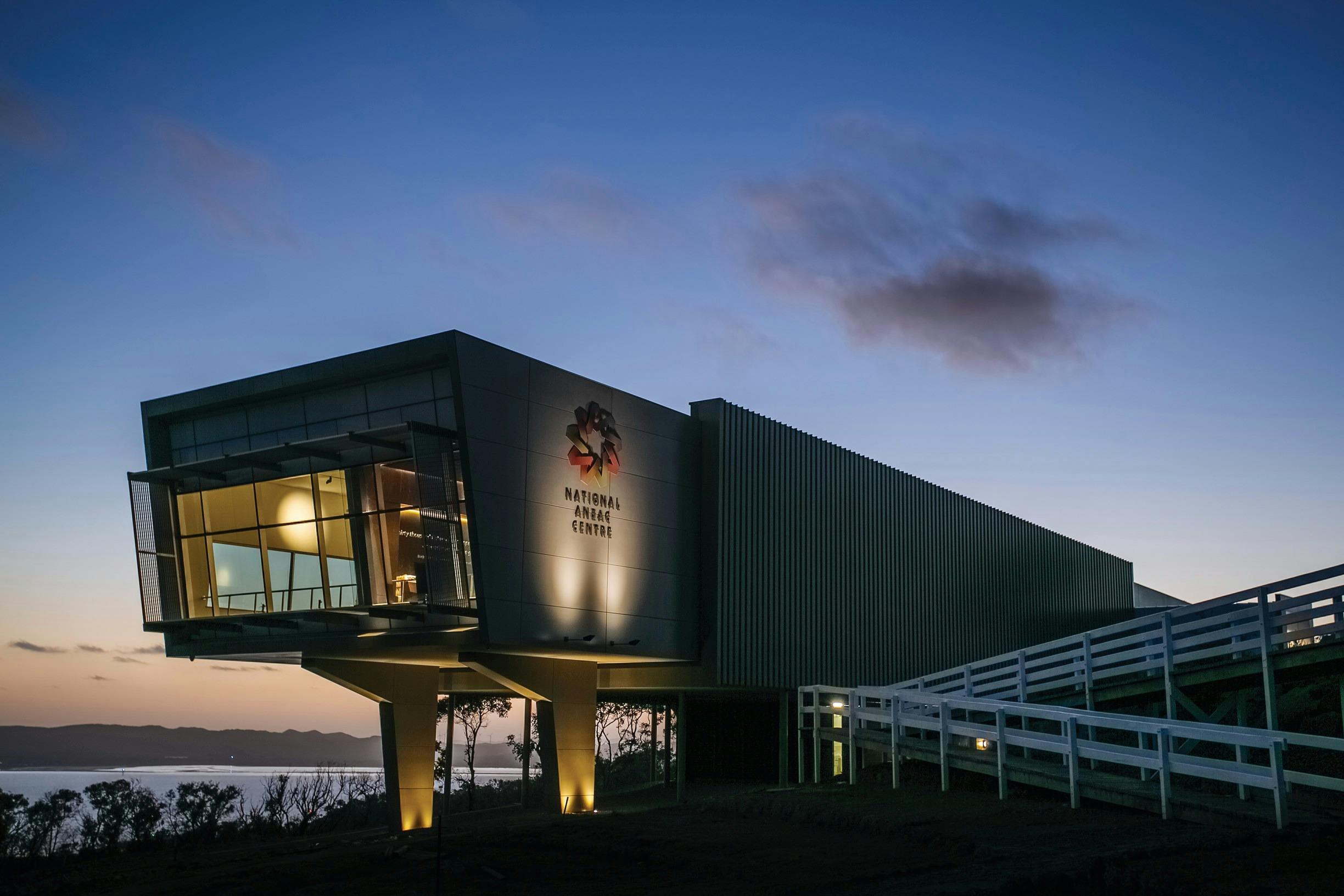 Exterior shot of The National Anzac Centre, at night. The National Anzac Centre is located within th