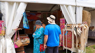 Buyers looking at artwork at the AIATSIS Indigenous Artwork