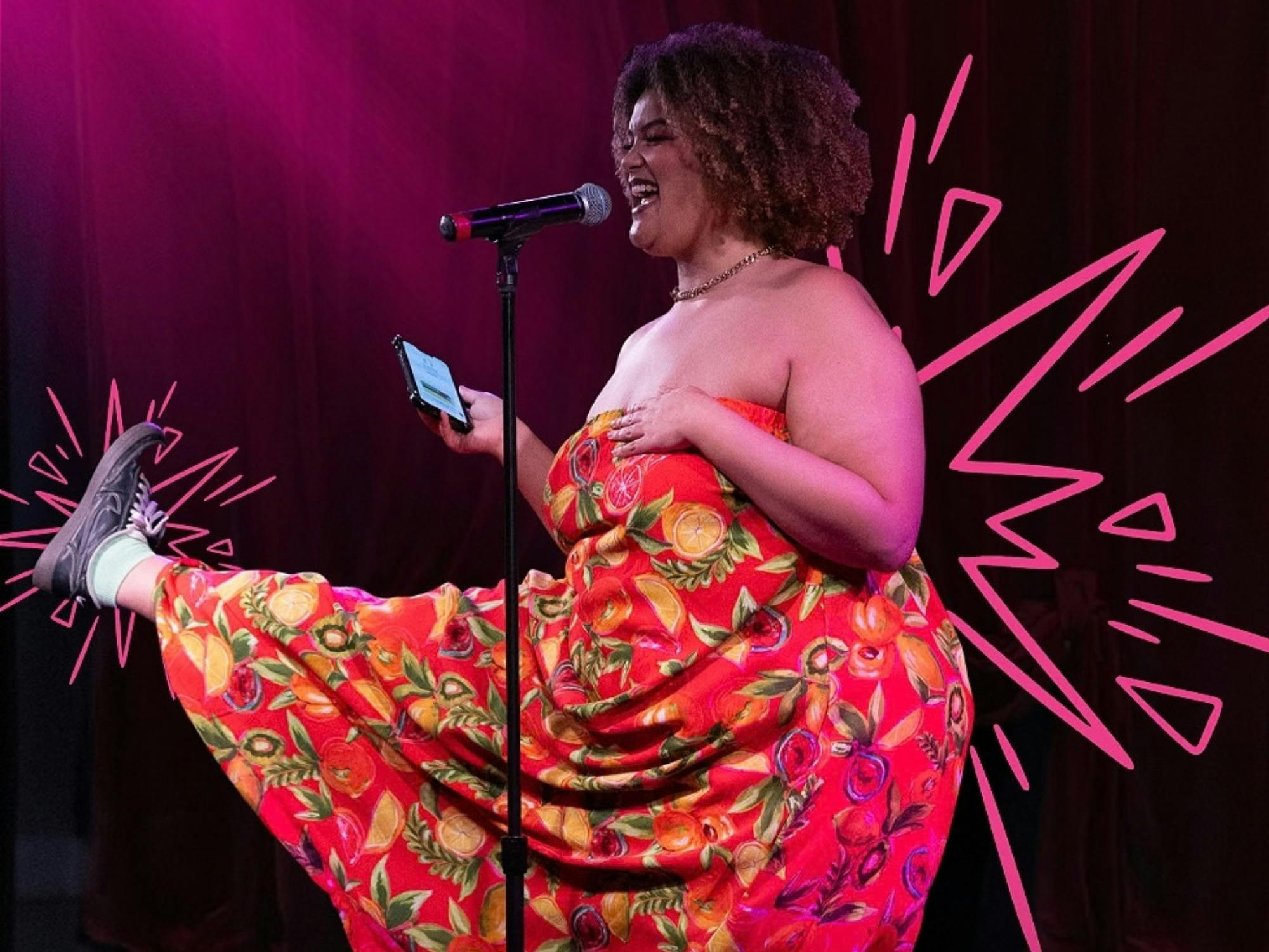 Performer in a red dress laughs on stage kicking one leg playfully framed by hot pink burst graphics