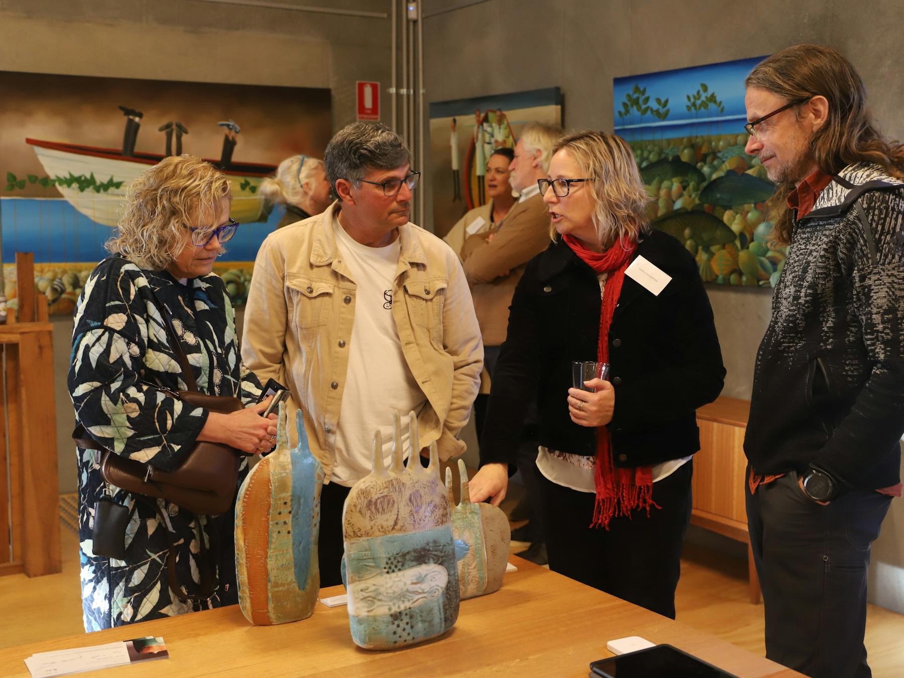 Image of several people interacting in gallery