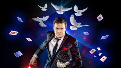 a magician with white doves flying above him with Playing cards falling around him.