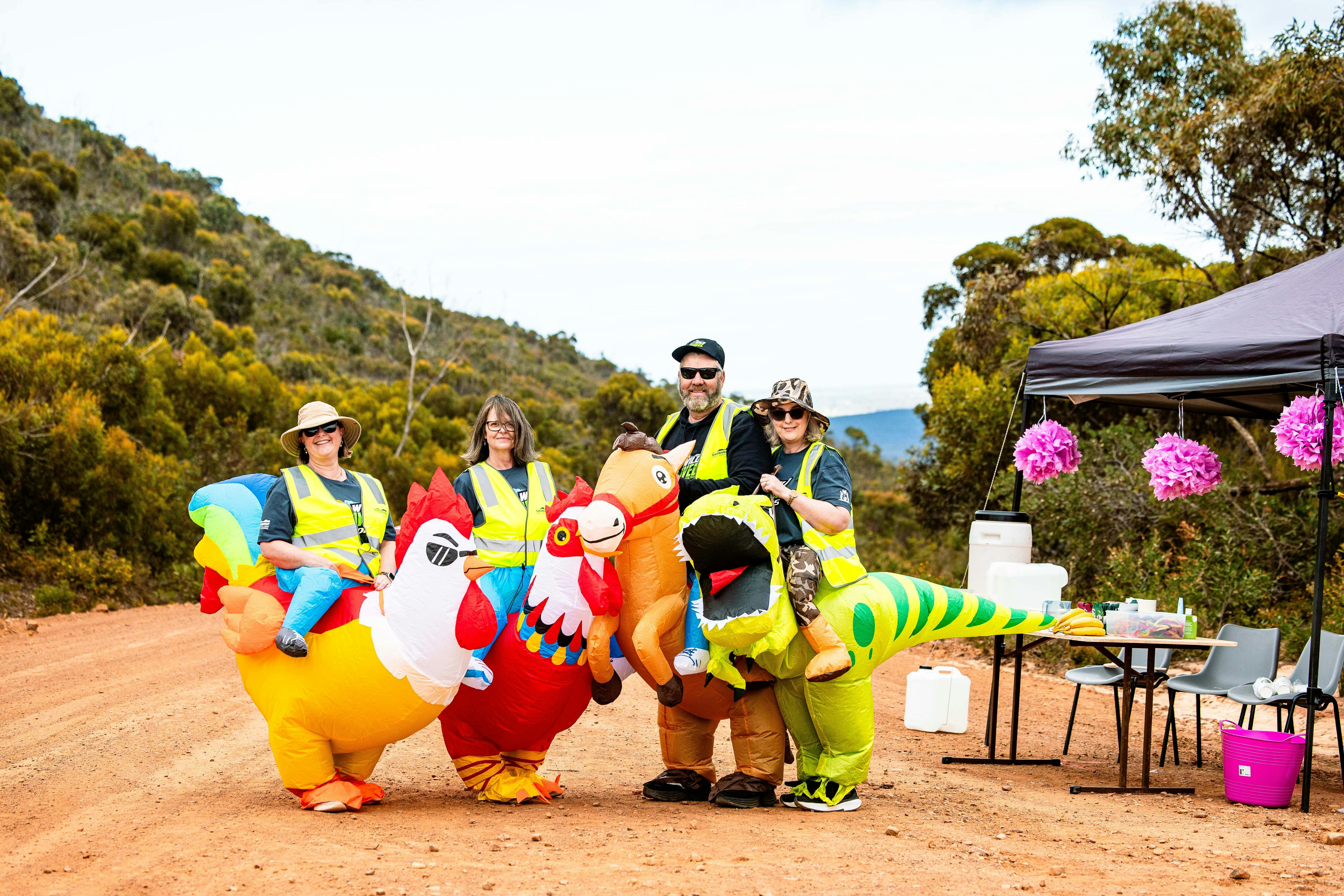 Volunteer pit stop attendants dressed in inflatable outfits