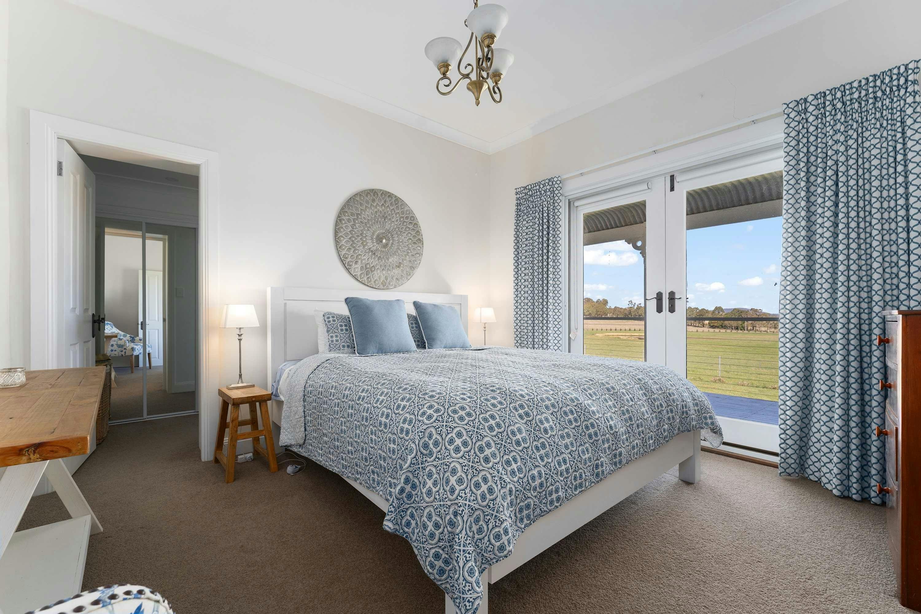 Beautiful king bedroom with doors to the verandah and WIR