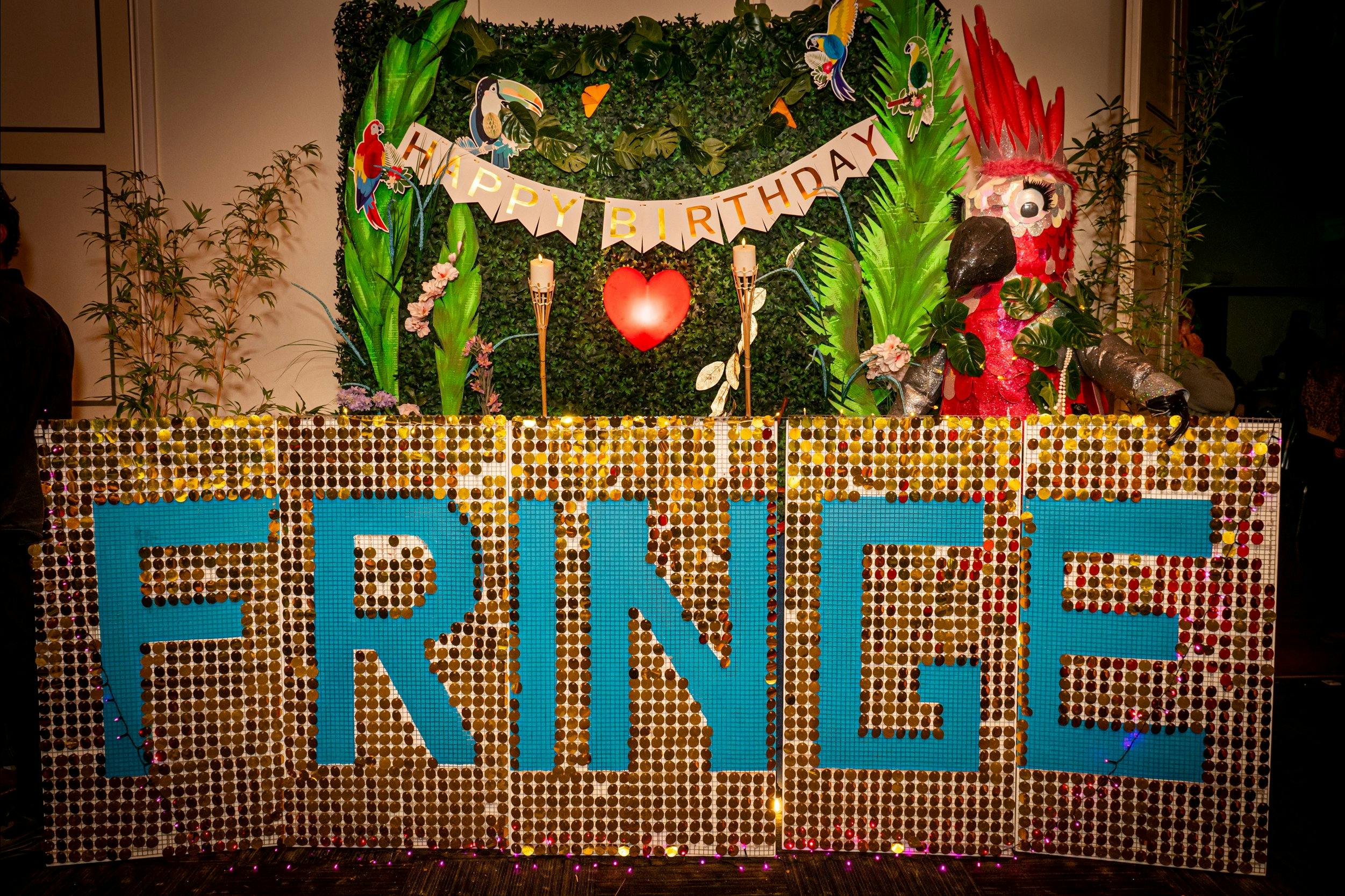 Photo of a sparkled gold and blue banner with the word FRINGE writen on it