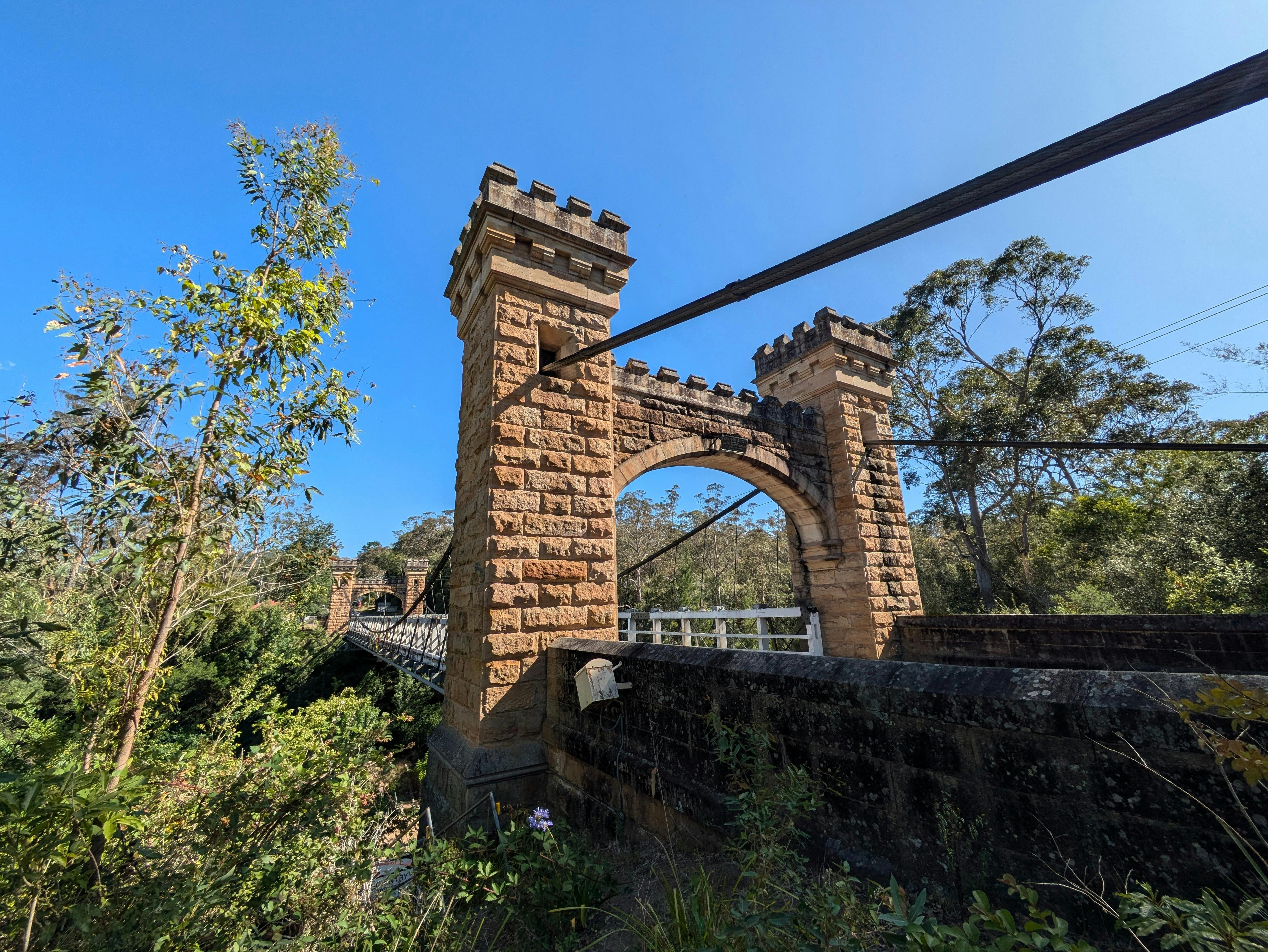 An old wooden and stone suspension bridge