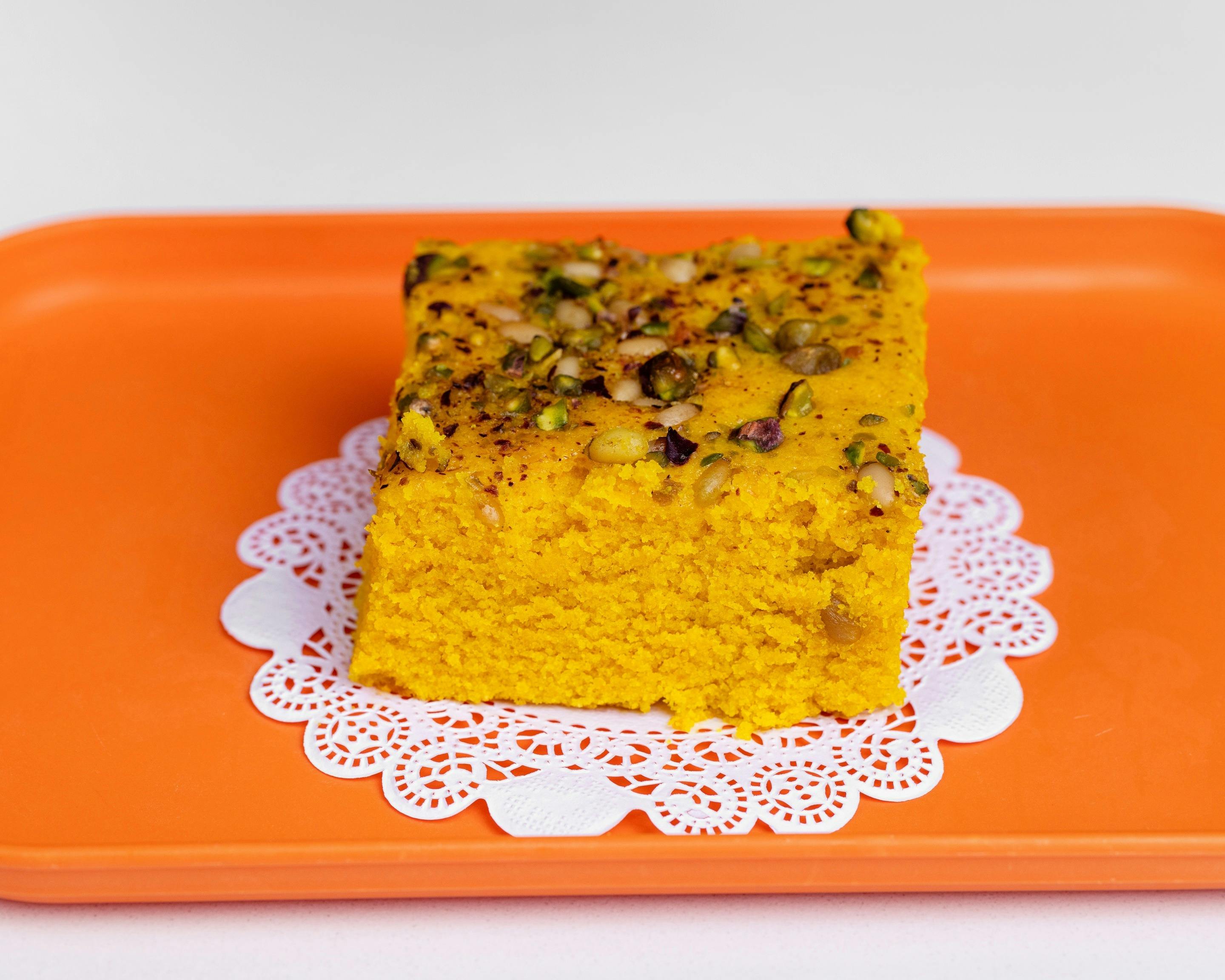Smeed Tumeric cake on an orange tray