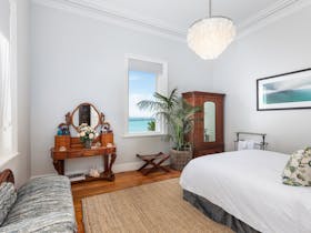 A large Queen bedroom with luxury furnishings, stunning views and historic features