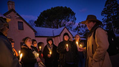 Tim the Yowie Man explaining something at Lanyon Homestead at dusk