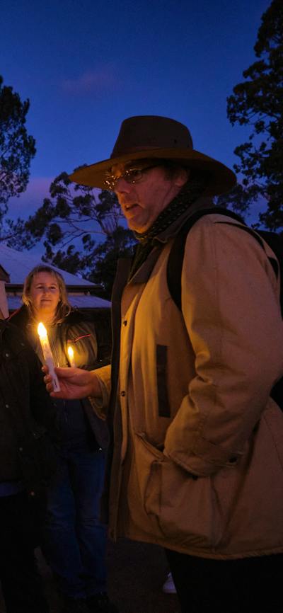 Tim the Yowie Man explaining something at Lanyon Homestead at dusk