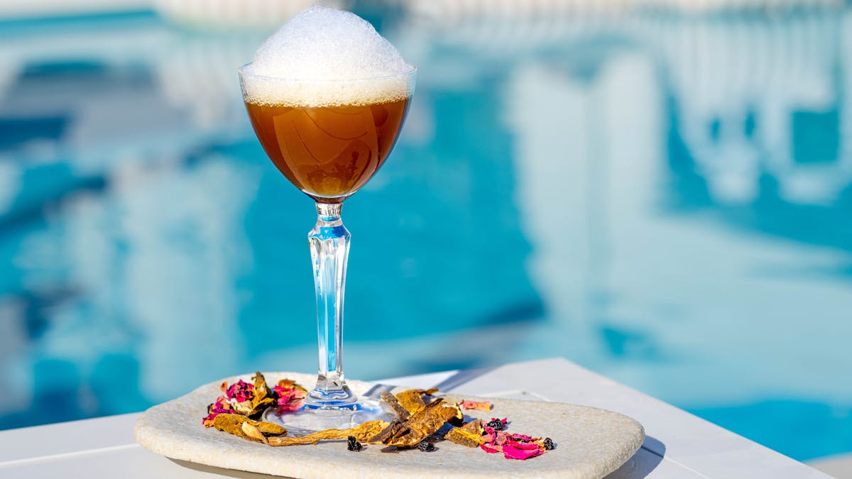 Poolside cocktail at La Luna Beach Club overlooking the marina