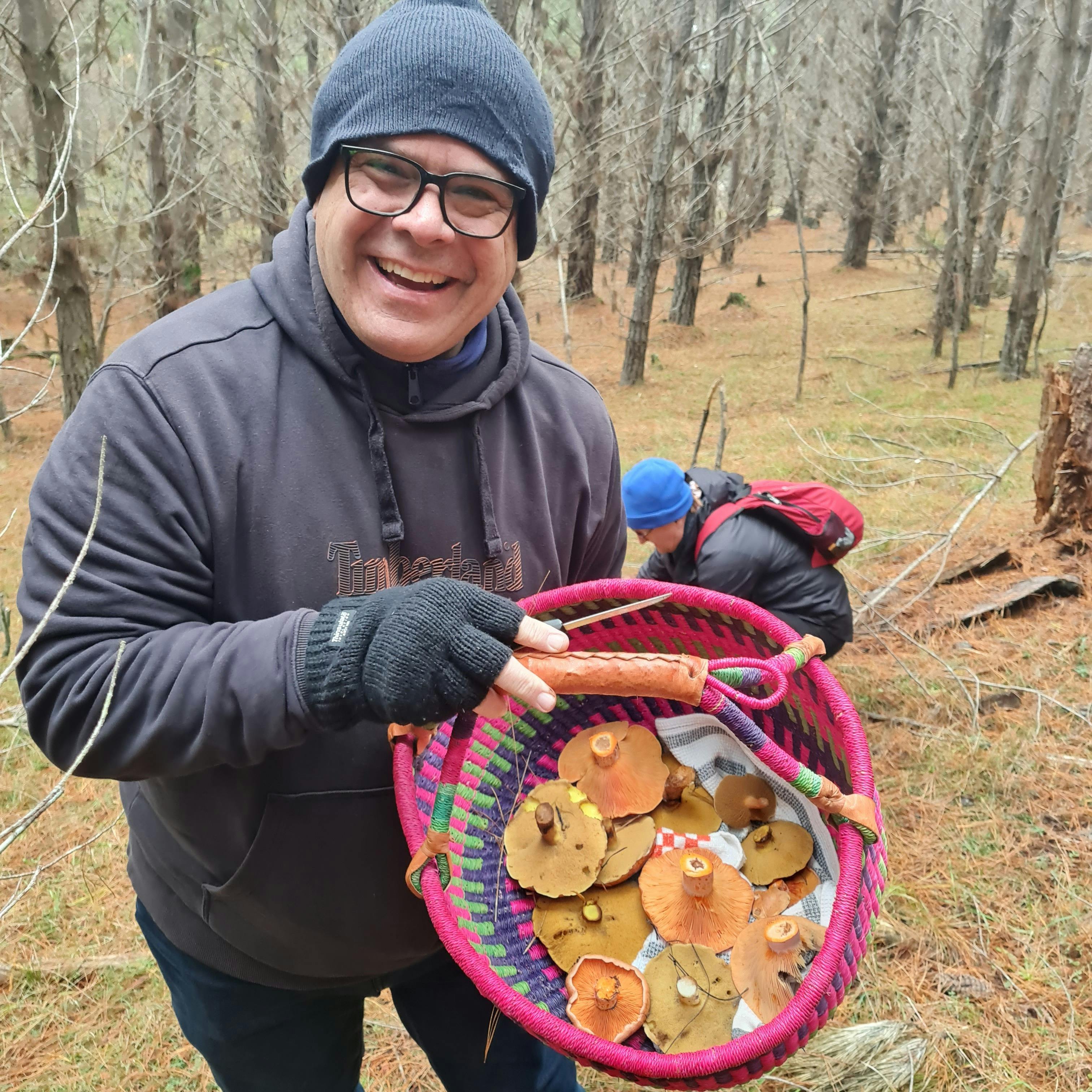 Mushroom forager with a basket of mushrooms