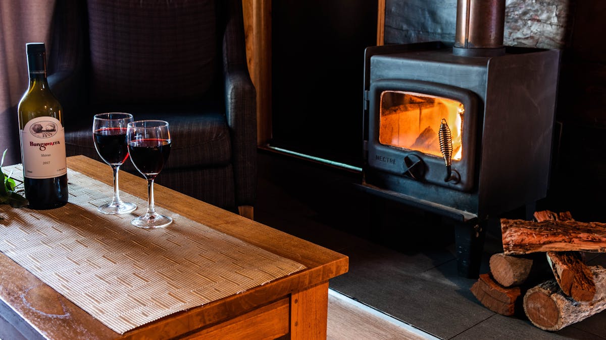 Granite Belt Retreat wine in front of the cabin log fire