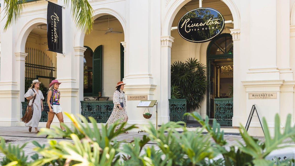Three young women walking outside a heritage listed building
