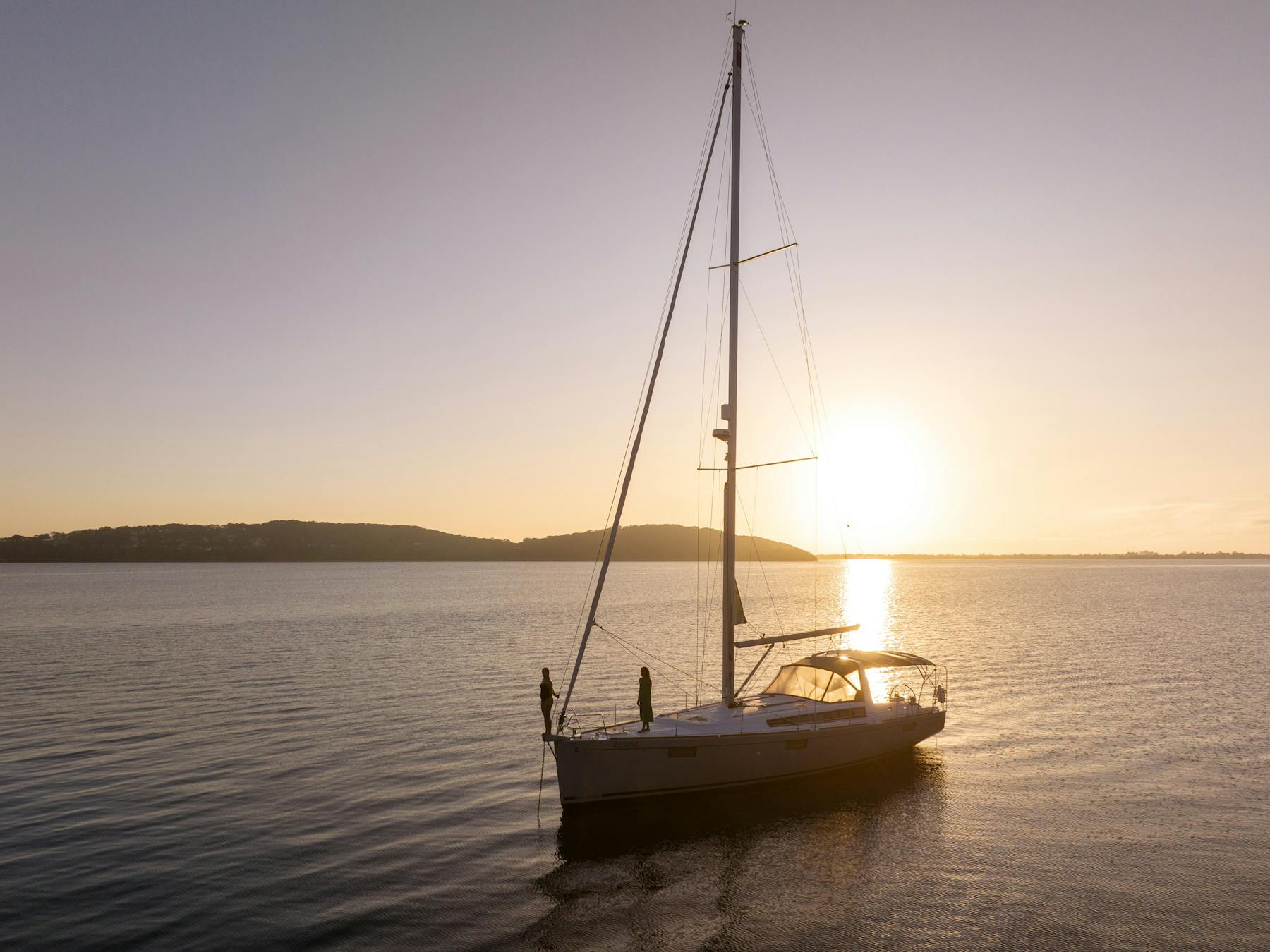 Standing on the bow with Sail Lake Macquarie, with the sun in the background