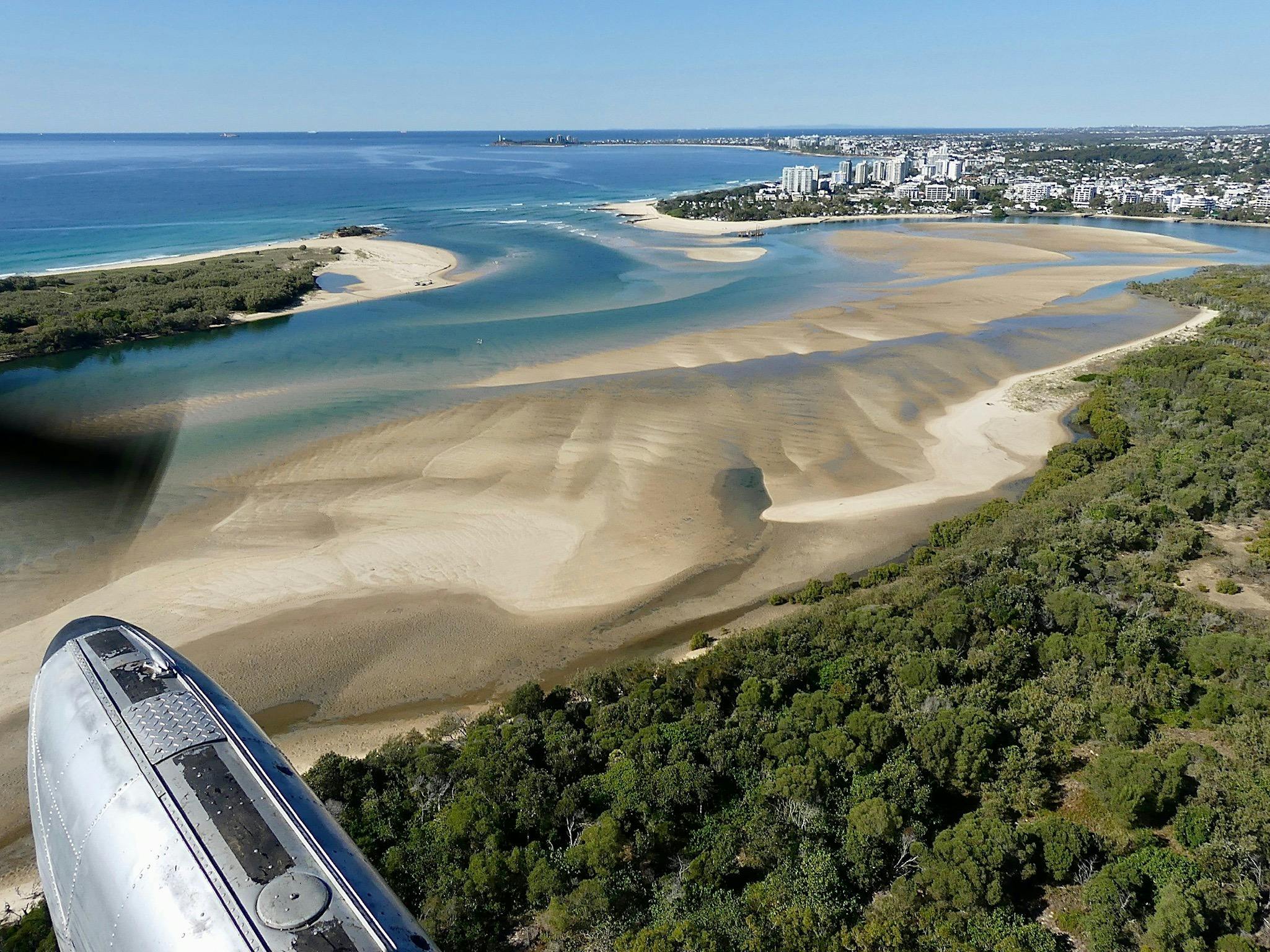 View with doors off from seaplane over Maroochy River estuary.