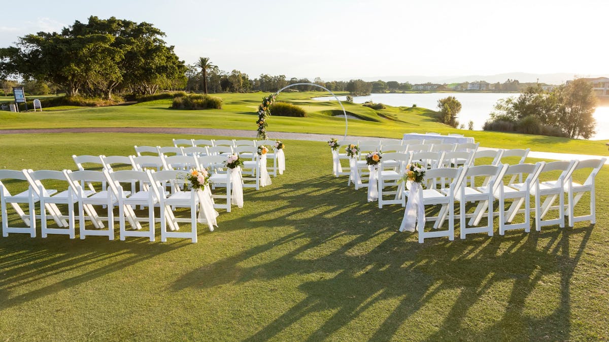 Chairs set up on the golf course facing the 18th hole