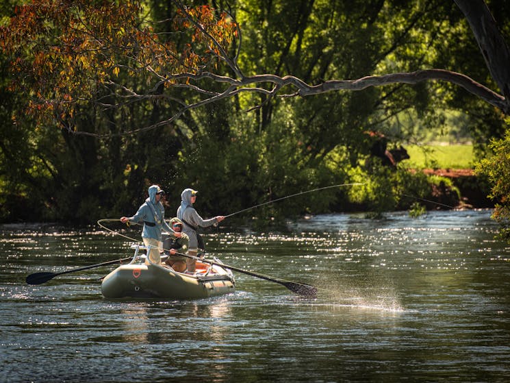 Drifting down the Tumut River fly fishing for trout.