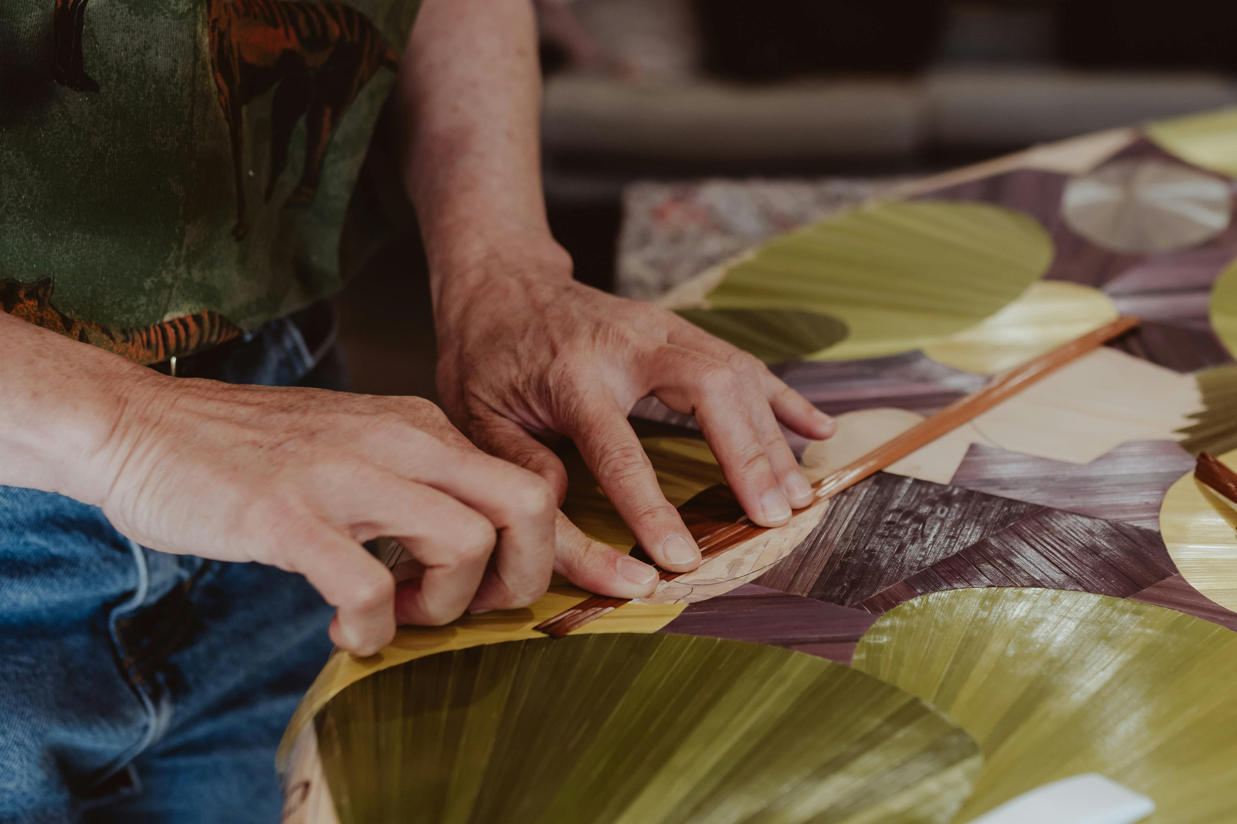 Inke Falkner using the technique of French straw marquetry on her artwork Round and Round