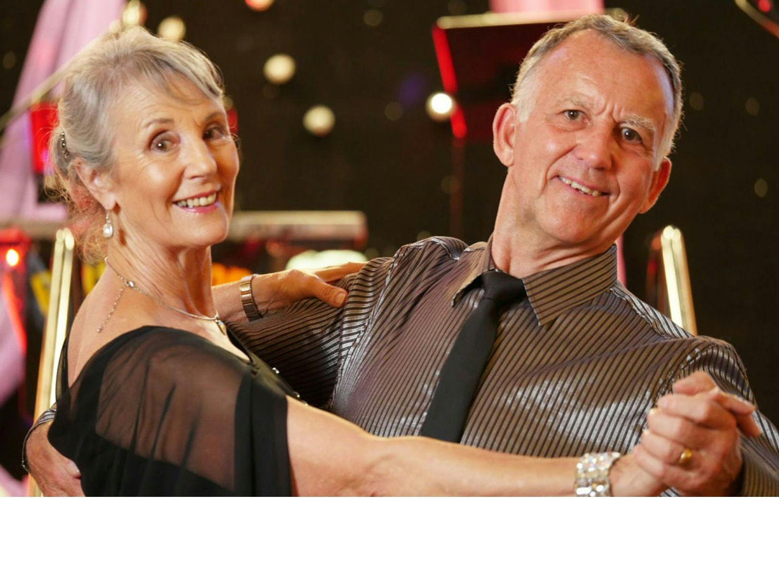 Two ballroom dancers poised to dance